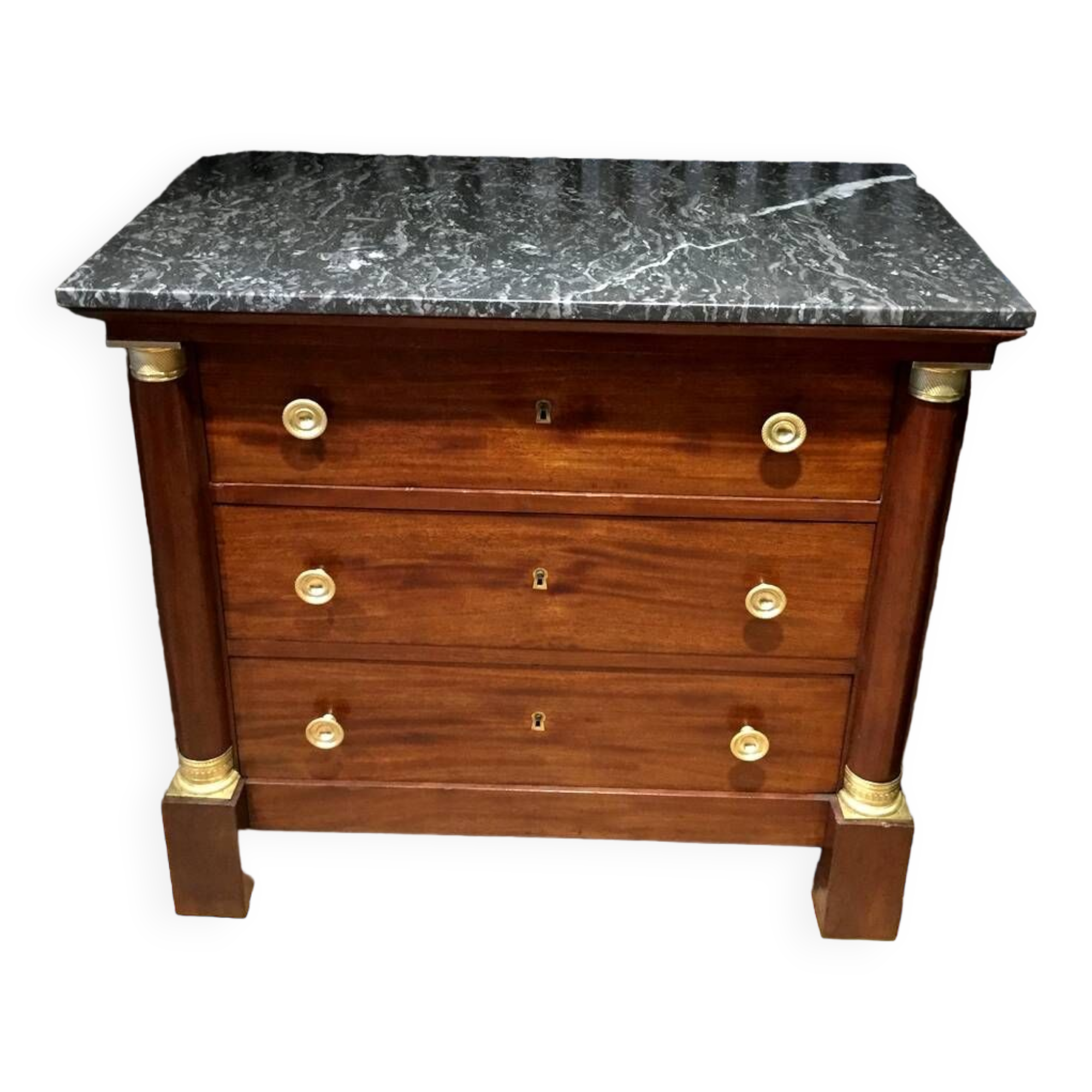 Empire chest of drawers with half columns in mahogany and gilded bronze