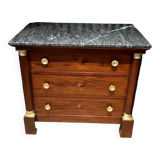 Empire chest of drawers with half columns in mahogany and gilded bronze