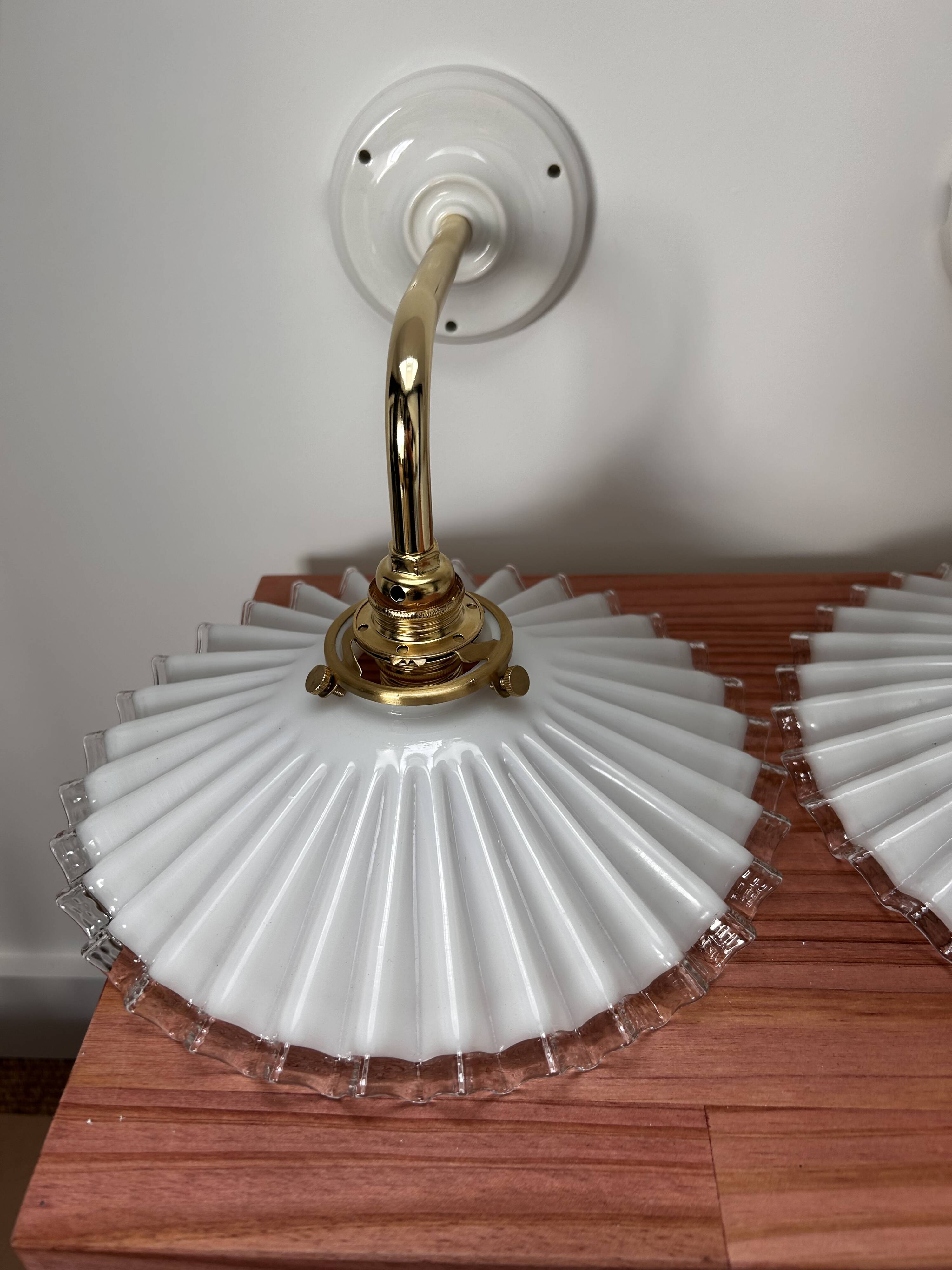 Two wall sconces in serrated white opaline