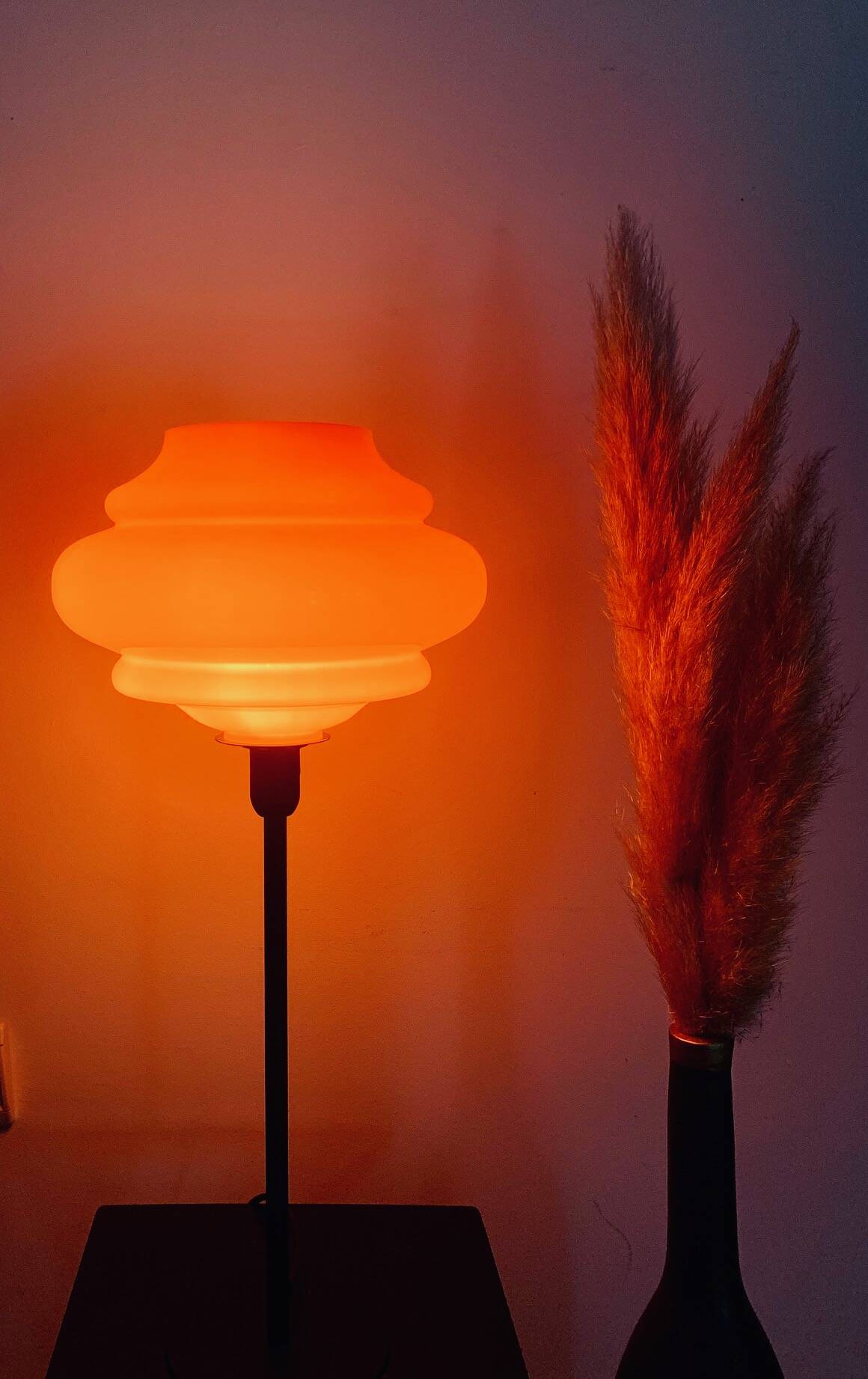Table lamp with a vintage orange globe from an old pendant light