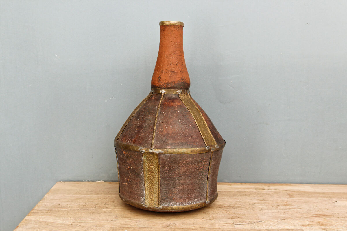 Old terracotta and brass bottle