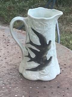Jade green ceramic barbotine vase with swallows.