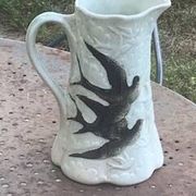 Jade green ceramic barbotine vase with swallows.