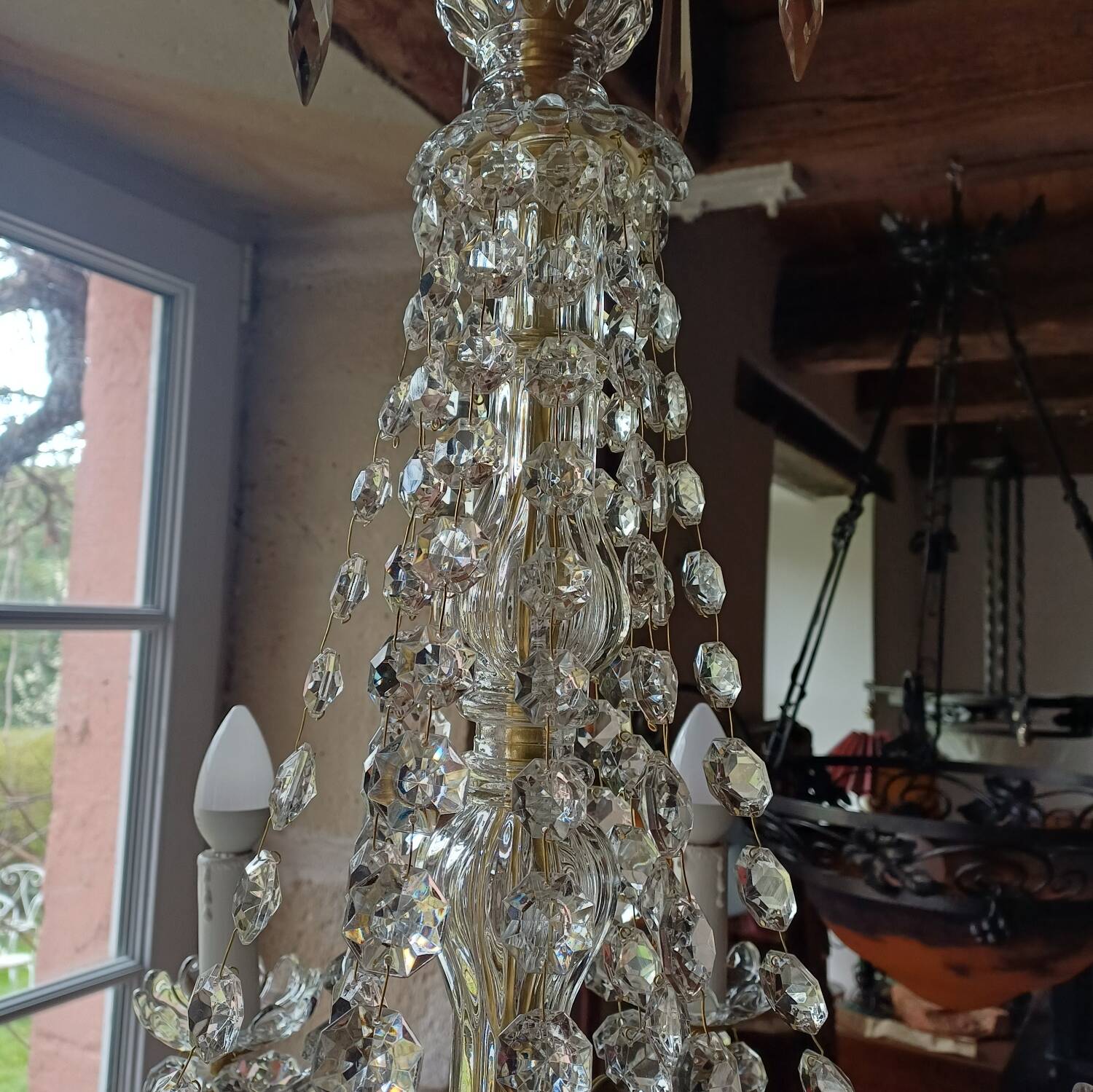 Antique chandelier with pendants in bronze and crystal.