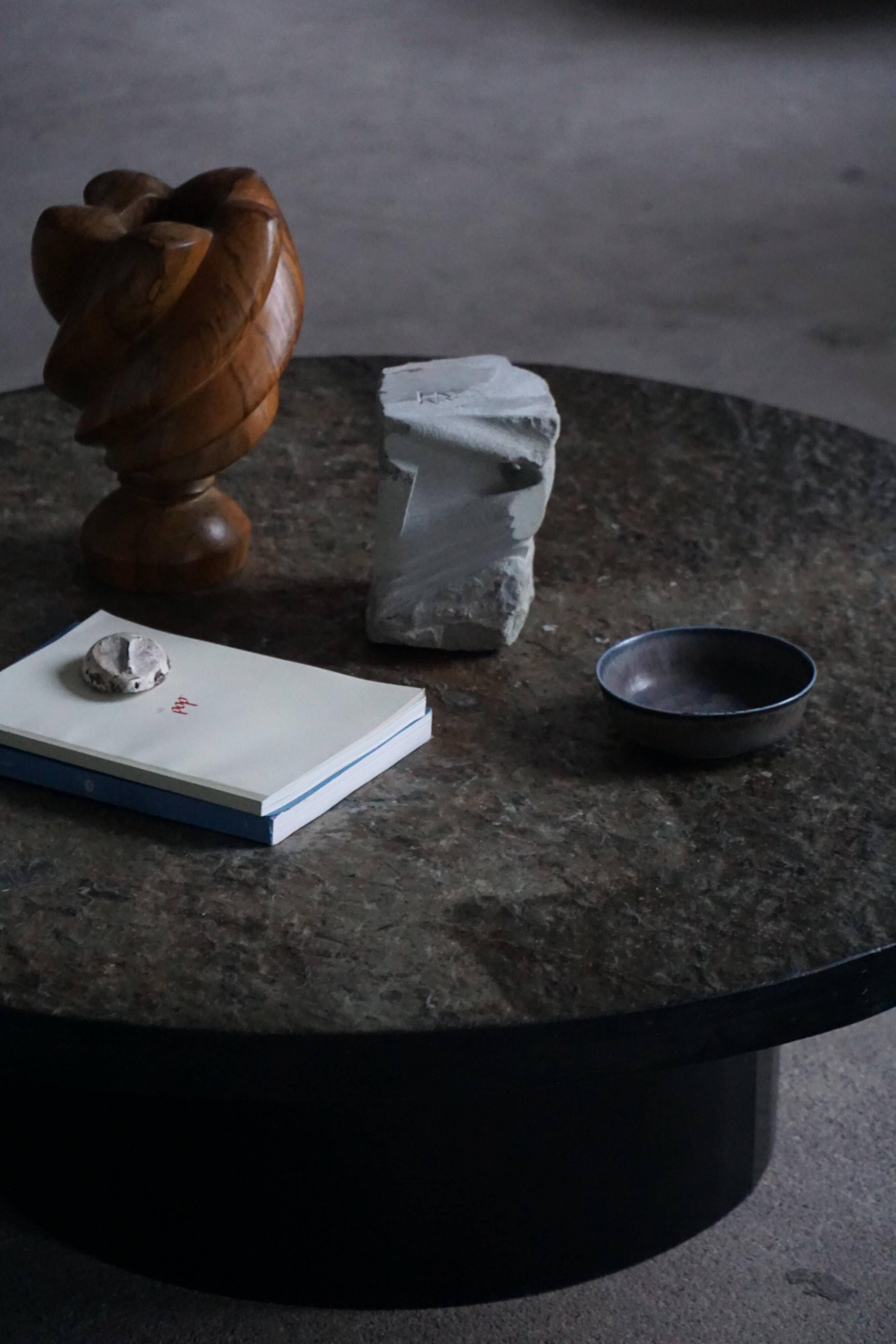Round brutalist coffee table in stone and steel, mid-century French modernism, 1970s.