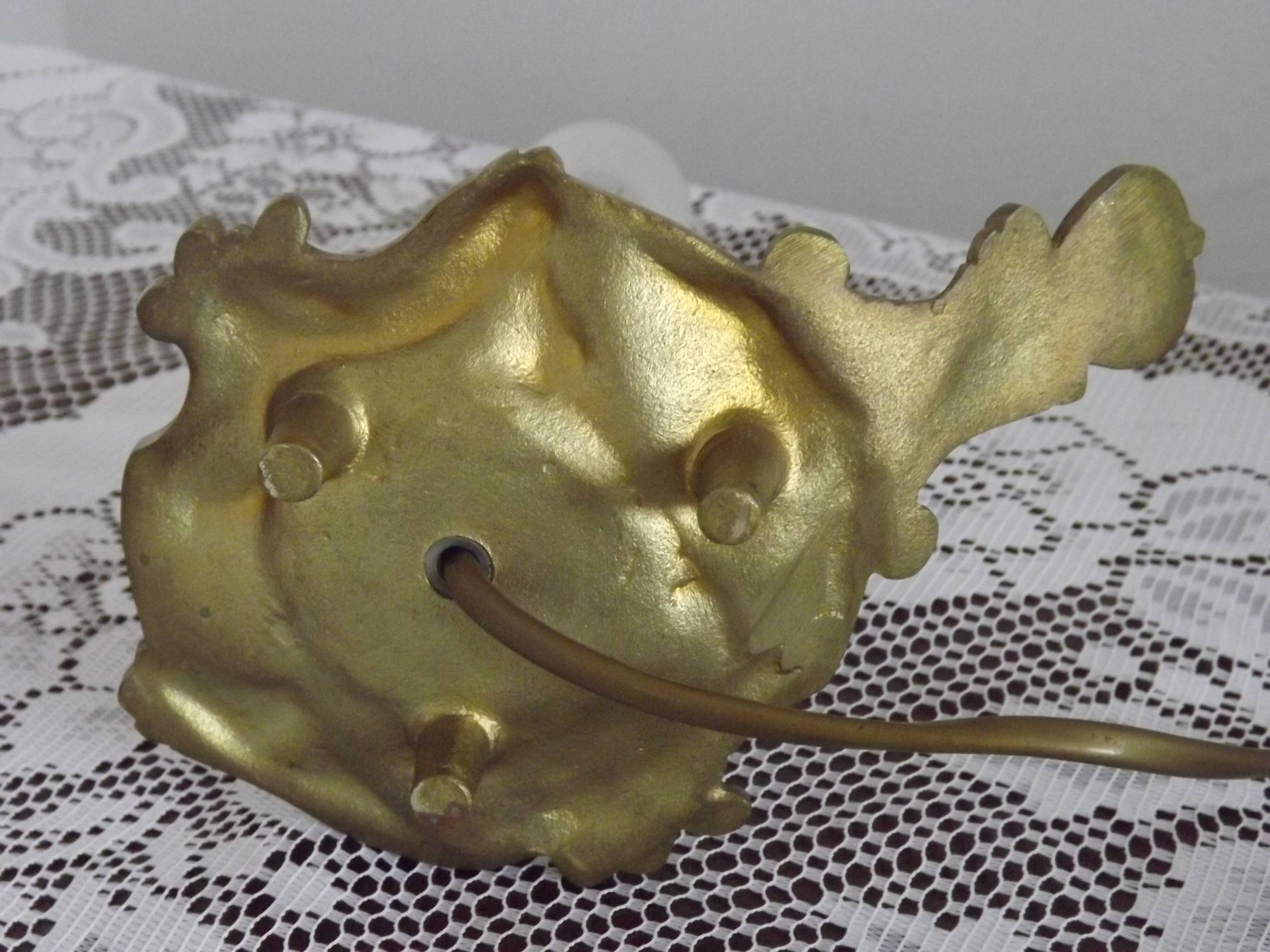 Vintage French bronze Wee Willie Winkie style lamp with red card shade.