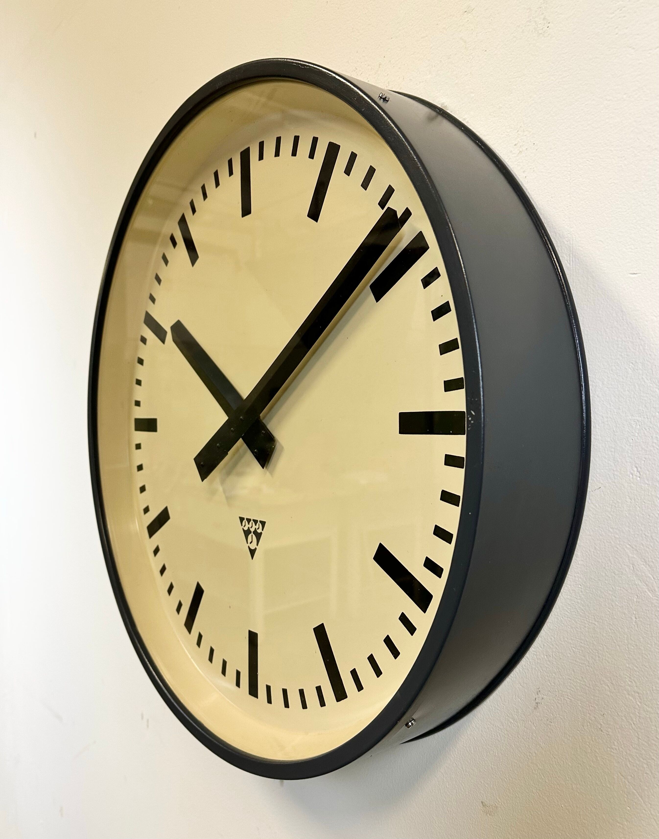 Grey industrial factory wall clock from pragotron, 1960s