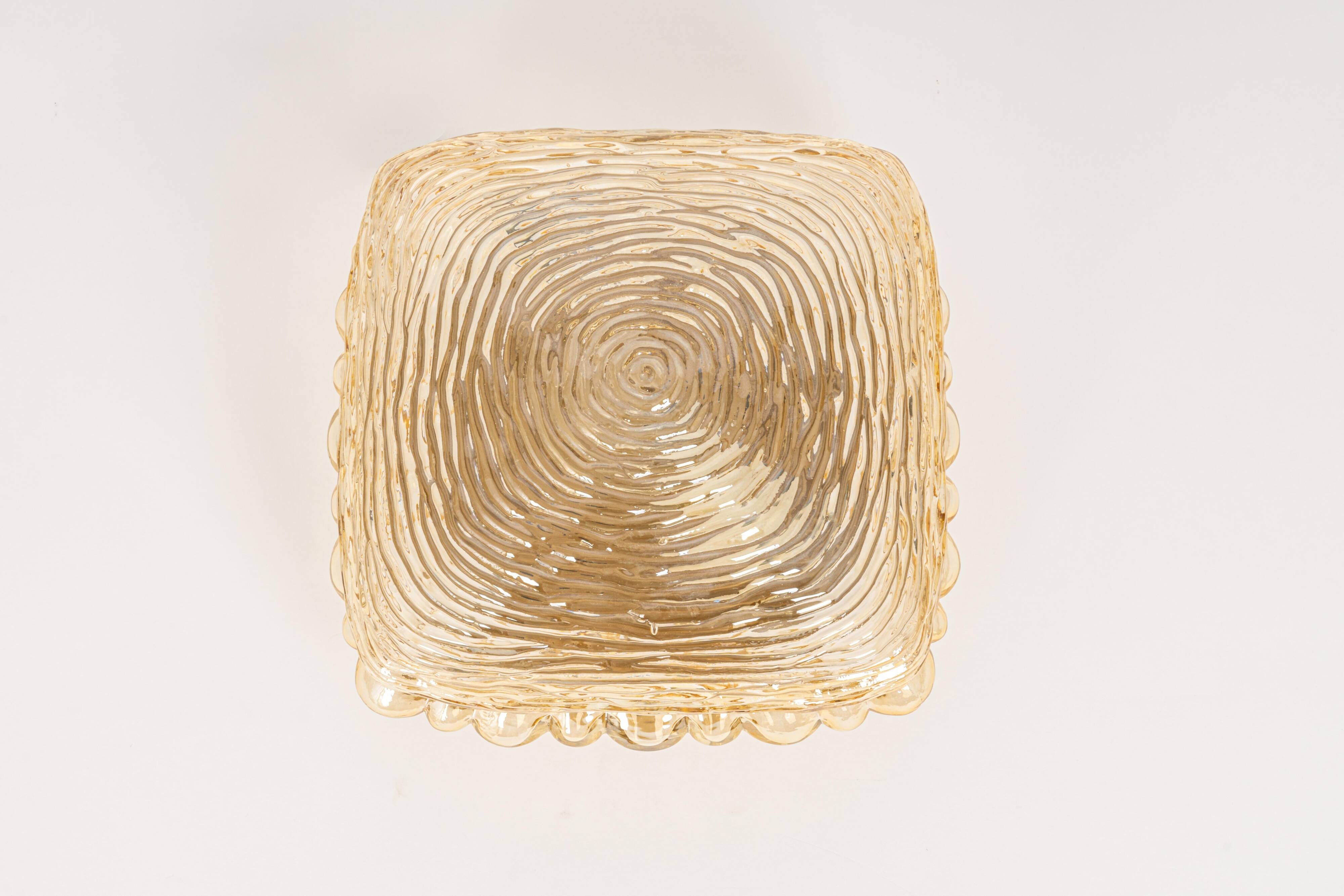 Pairs of amber glass wall lights in the shape of a fingerprint, Germany, 1970s.