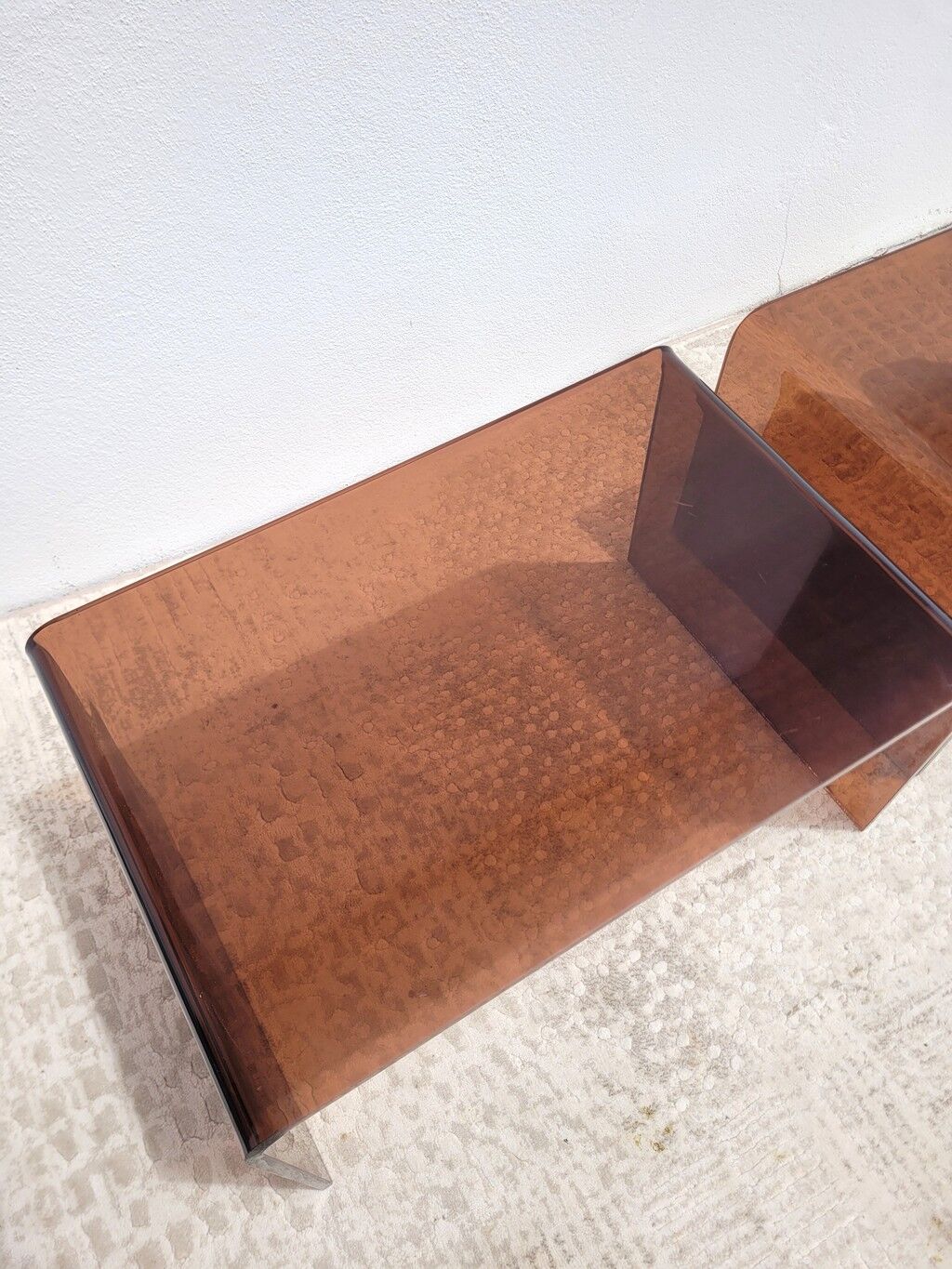 Pair of vintage smoked plexiglass nesting tables.