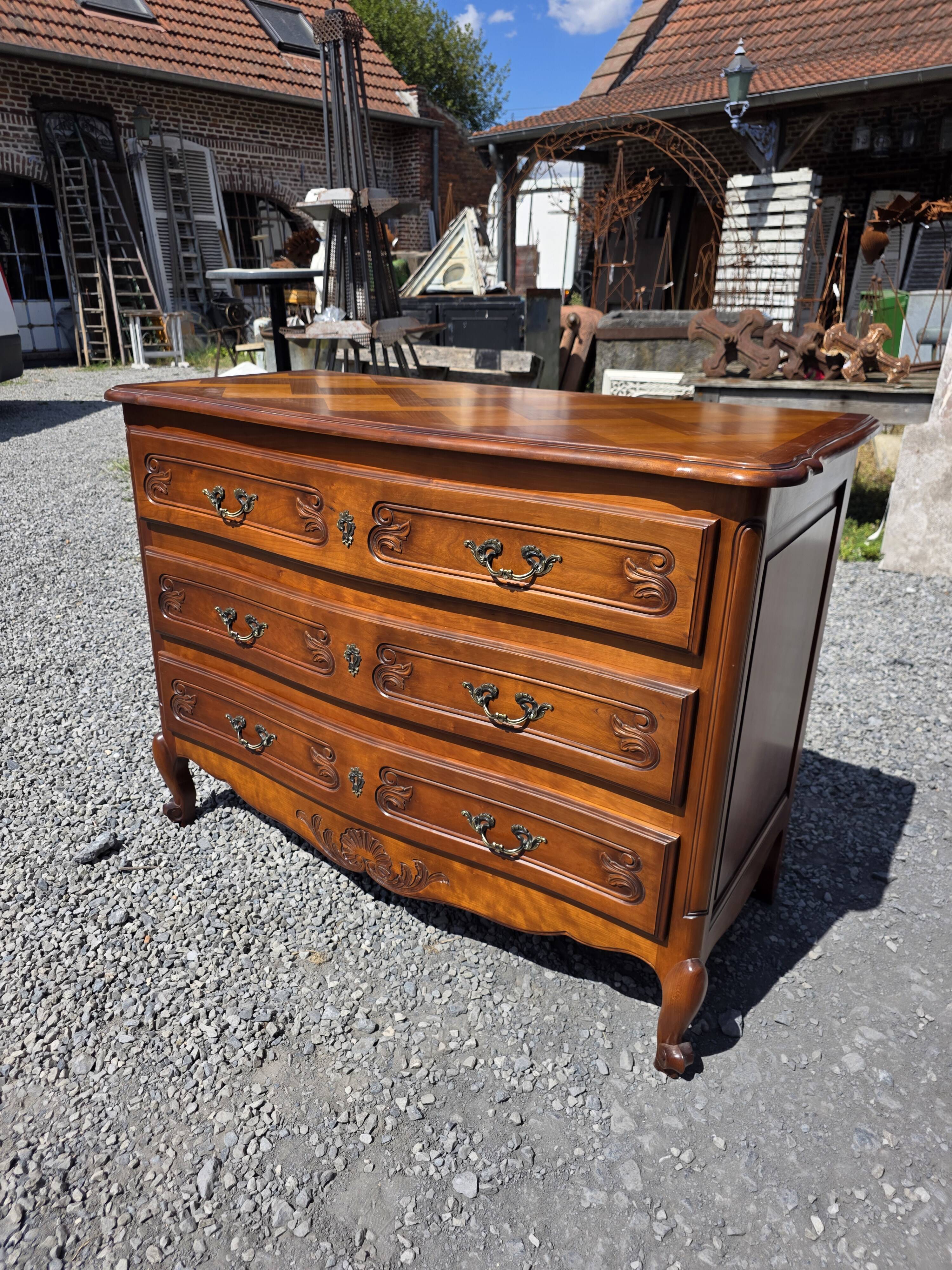 Curved commode in Louis XV style made of cherry wood.