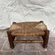 Rustic footrest made of wood and straw