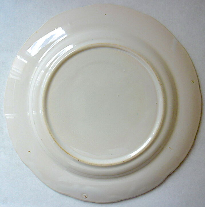 Eastern earthenware plate with floral decoration centered with a rose