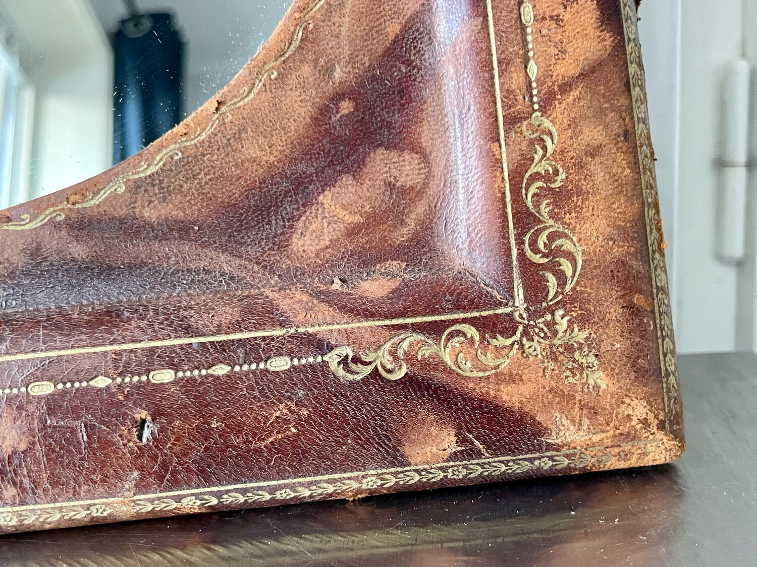 Antique leather framed mirror with gildings 30 cm x  24 cm