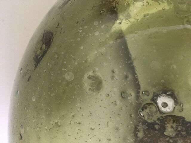 Old demijohn full of bubbles