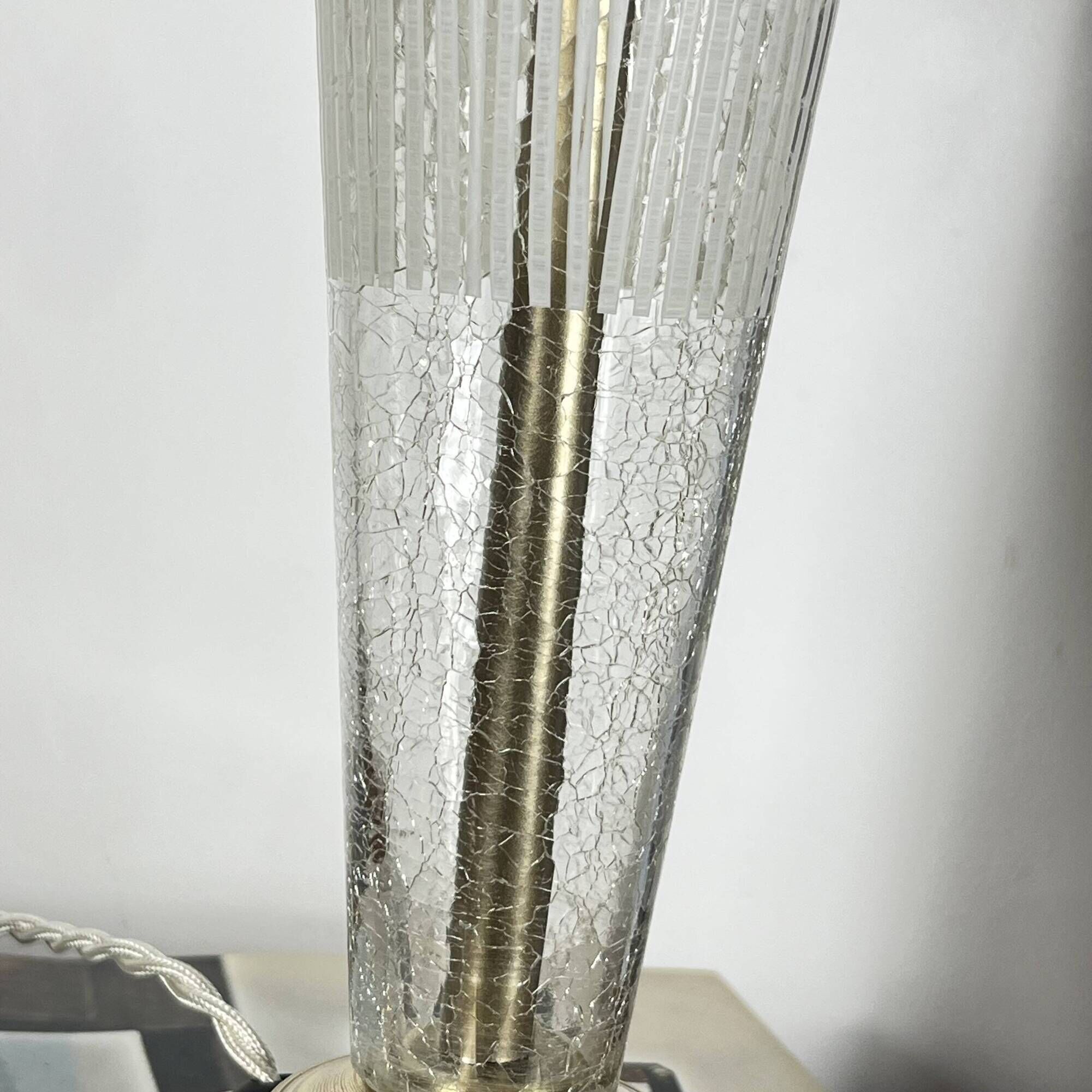 Large globe table lamp with a cracked glass base and brass stand.