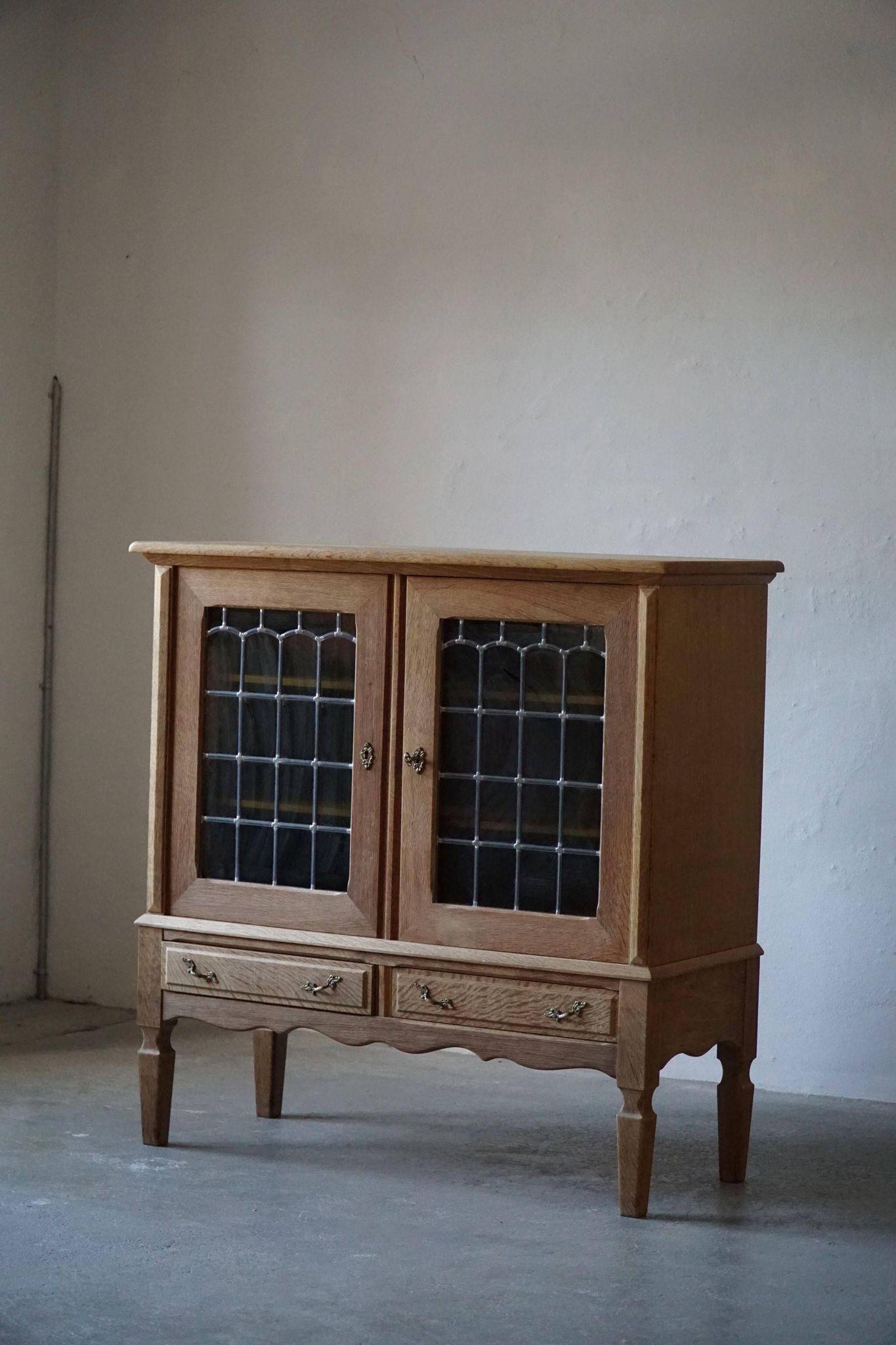20th-century mid-century solid oak sideboard with glass front, by a Danish cabinetmaker.