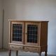 20th-century mid-century solid oak sideboard with glass front, by a Danish cabinetmaker.