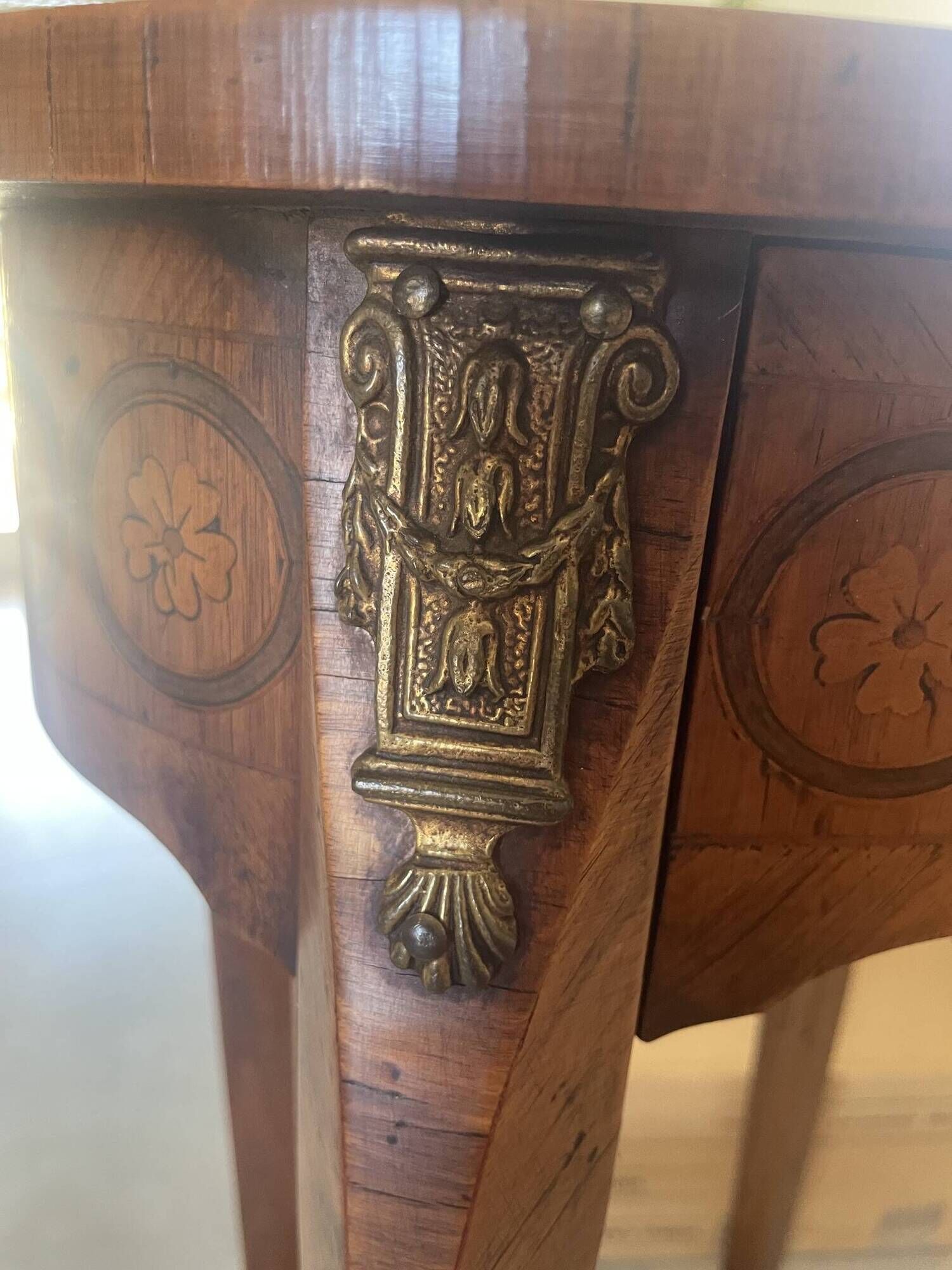 Oval bedside table from the Transition period in marquetry and bronze.