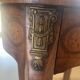 Oval bedside table from the Transition period in marquetry and bronze.