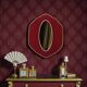 Oval wall mirror in burgundy velvet and brass – 1950s–1960s