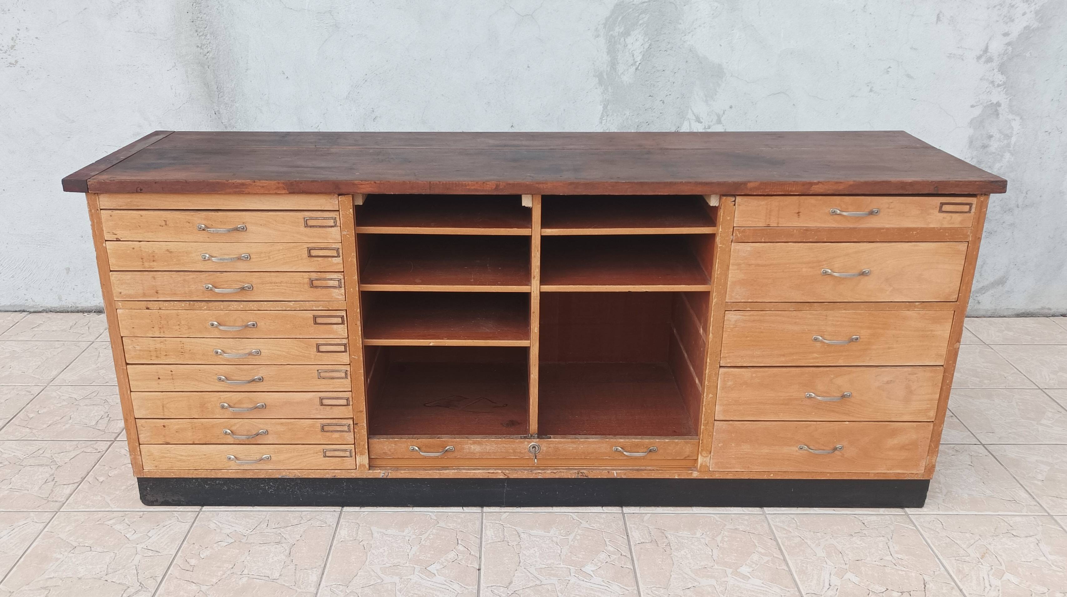 Workshop furniture with drawers and curtain in beech and walnut.