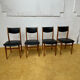4 Scandinavian chairs in teak and black faux leather.