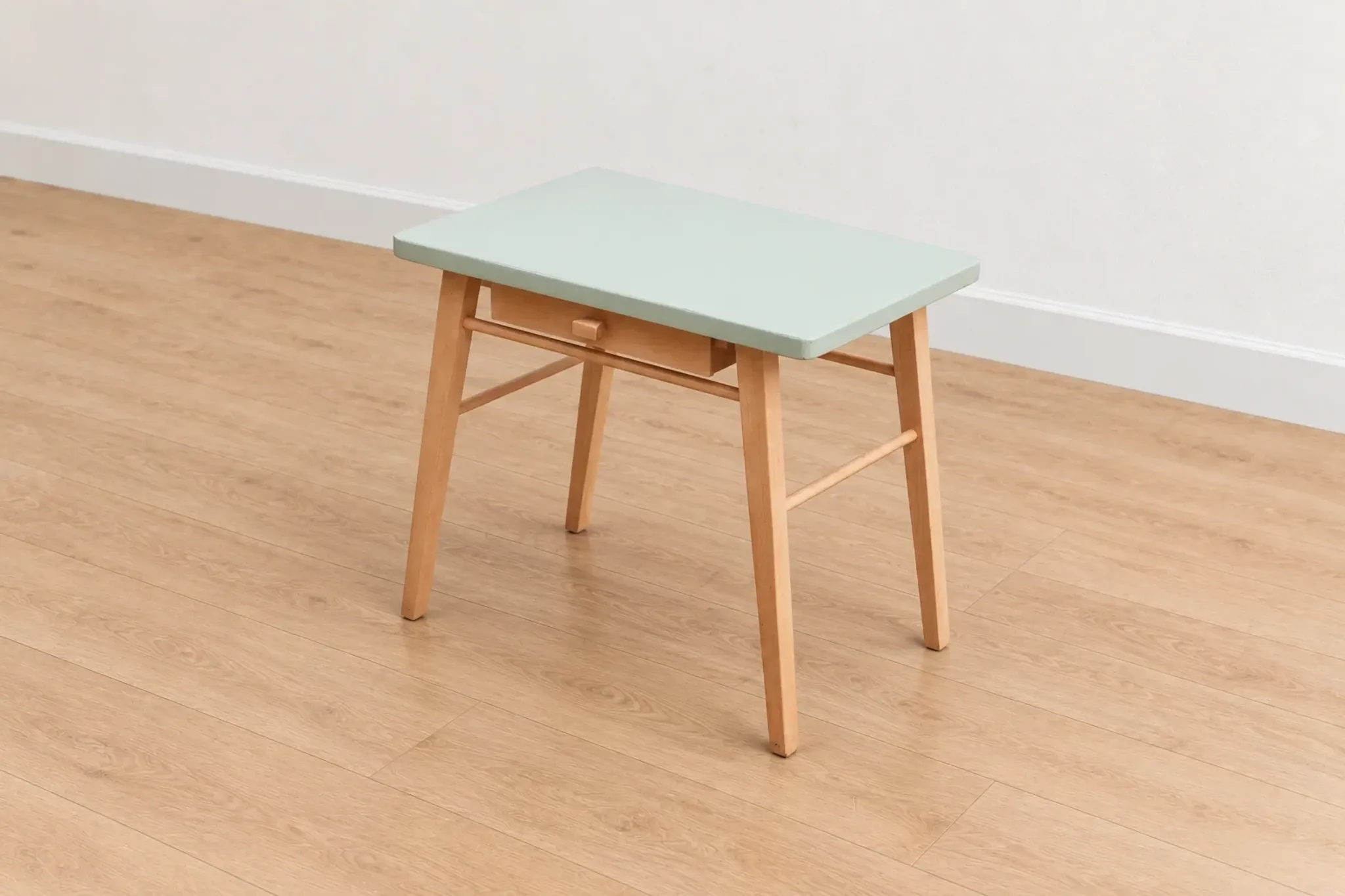Small vintage children's desk attributed to Baumann – natural wood and lizard green top.
