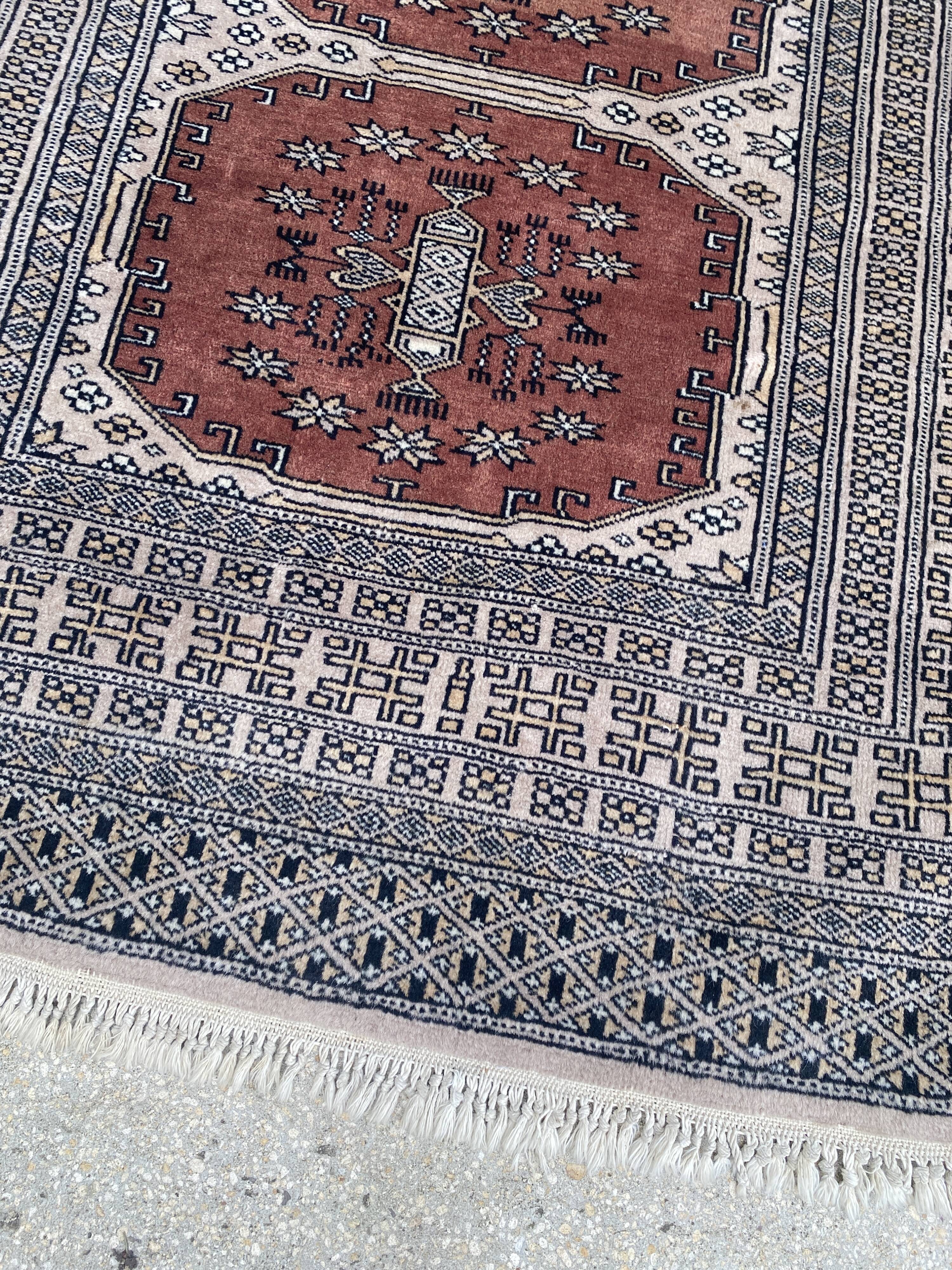 Vintage hand knotted rug with geometric patterns on a grey/beige/terracotta background 170 x 96 cm