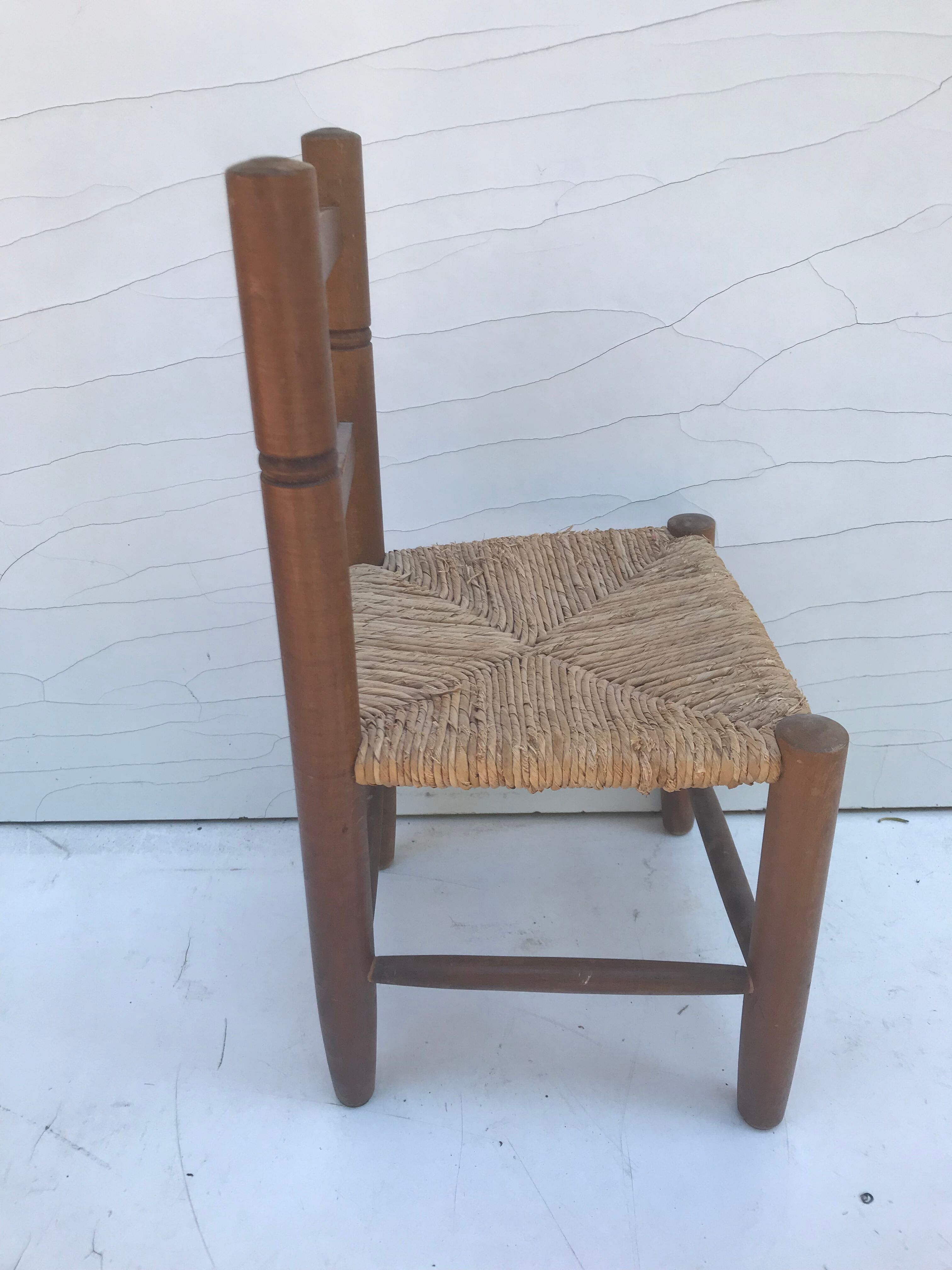 Old wooden children's chair with vintage braided seat