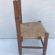 Old wooden children's chair with vintage braided seat