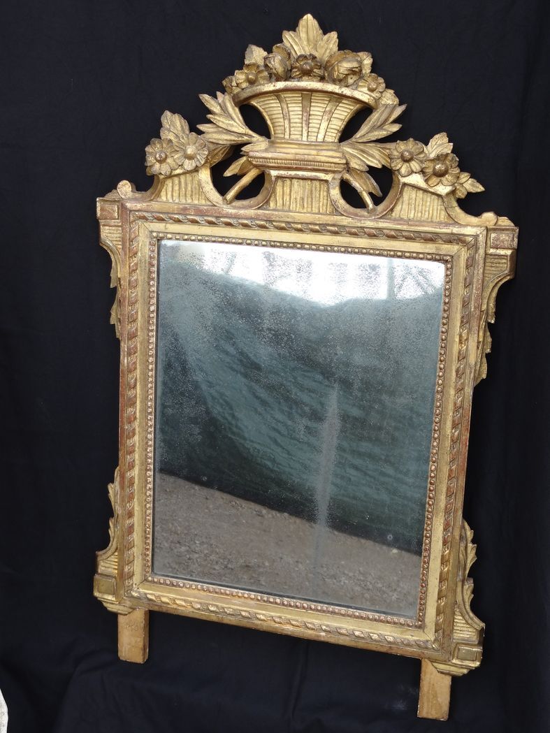 Louis XVI period mirror in gilded carved wood