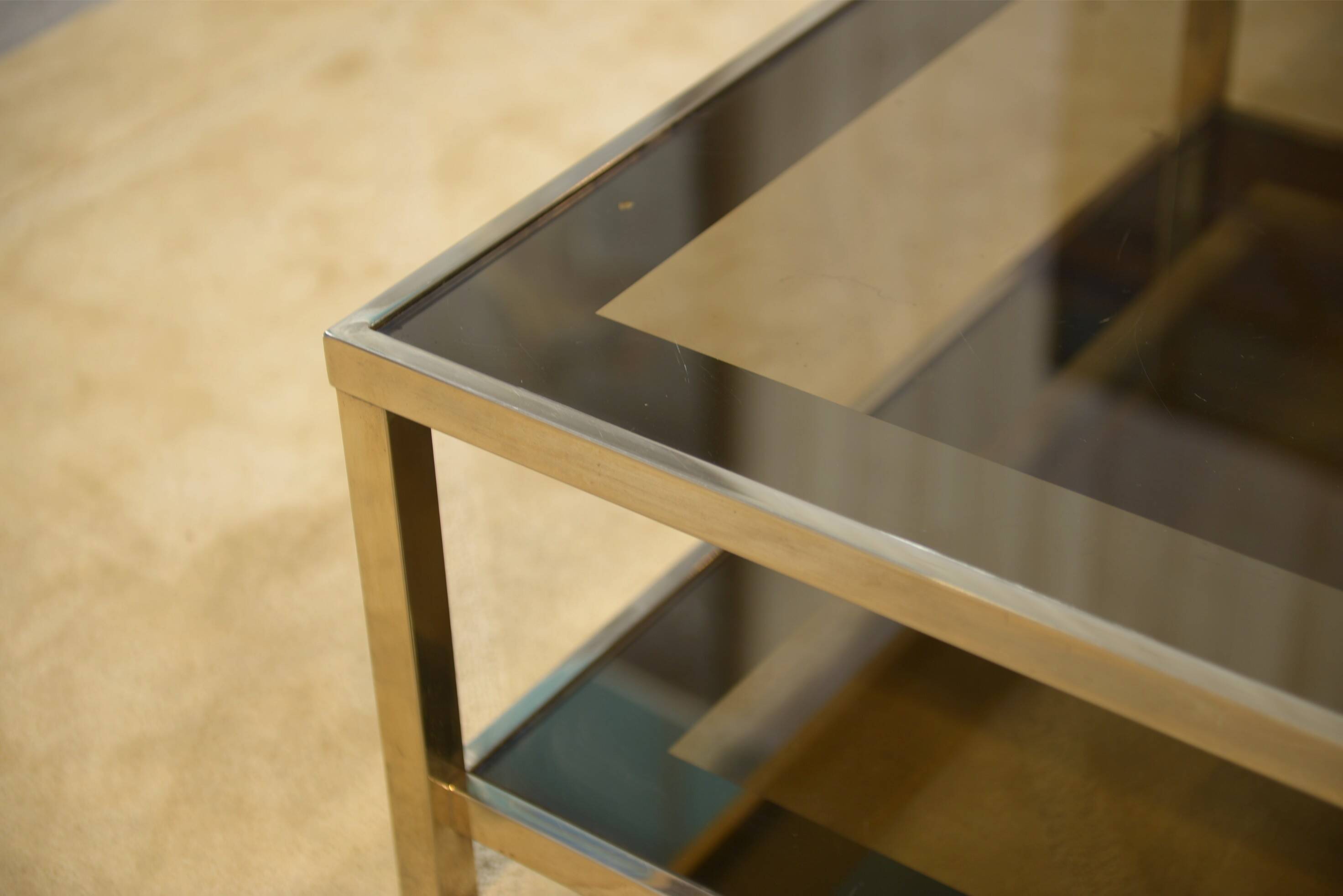 Hollywood Regency coffee table in smoked glass with mirrored framing from the 1970s.