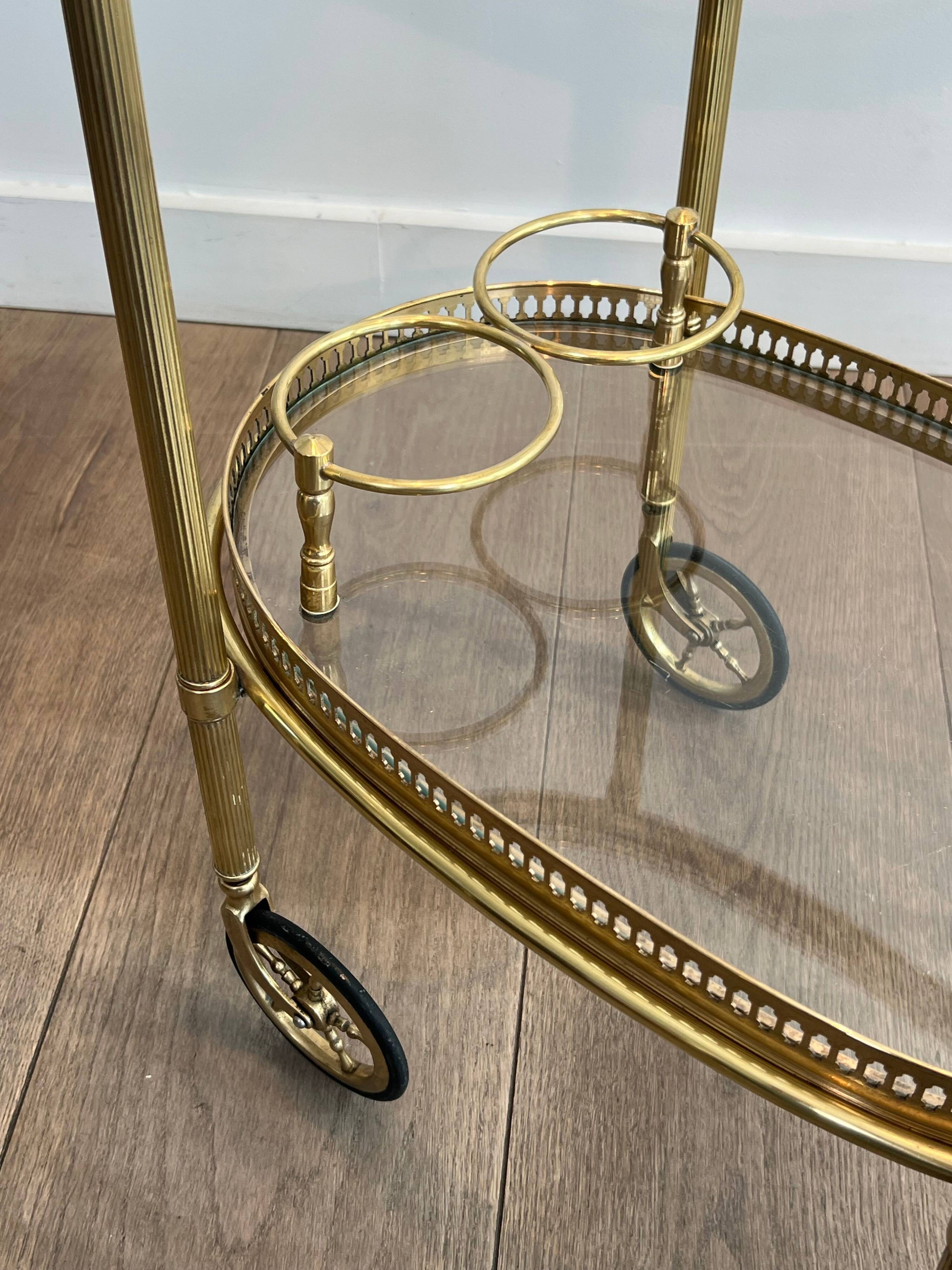 Small oval rolling table in brass with double removable trays from Maison Bagués.