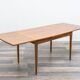 Dining table, 1960s, in walnut, slightly elliptical shape.