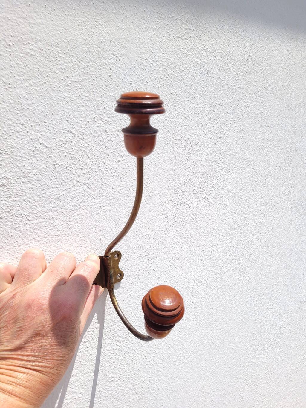 Pair of antique wooden and metal coat hooks