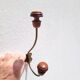 Pair of antique wooden and metal coat hooks