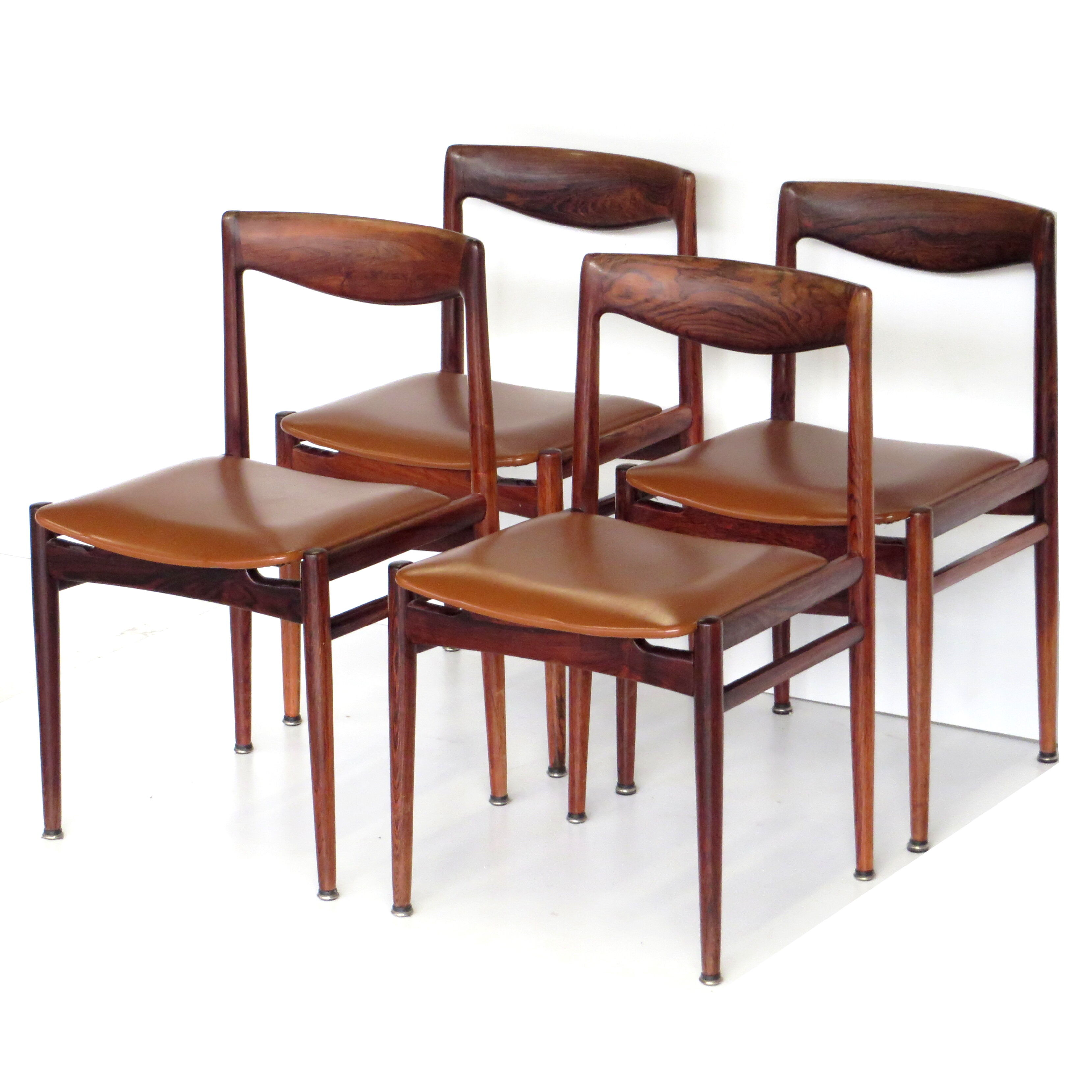 Set of four vintage mid century rosewood dining chairs with cognac leather seats
