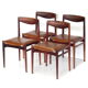 Set of four vintage mid century rosewood dining chairs with cognac leather seats