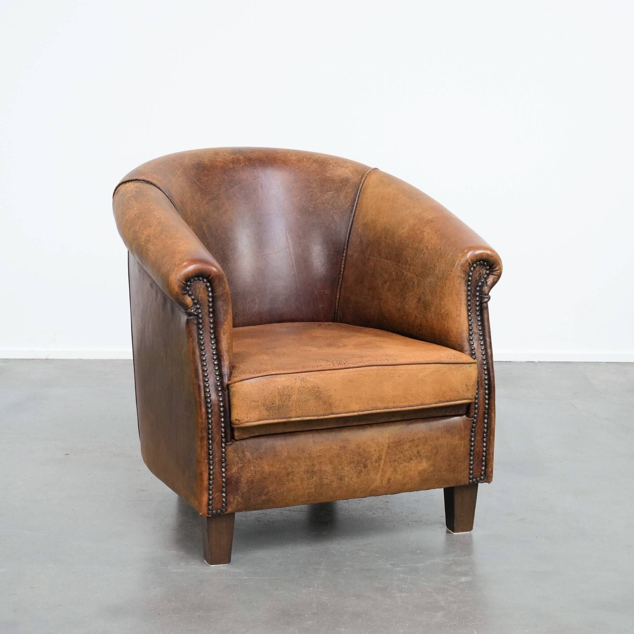 Vintage club chair in sheepskin leather with a characterful look