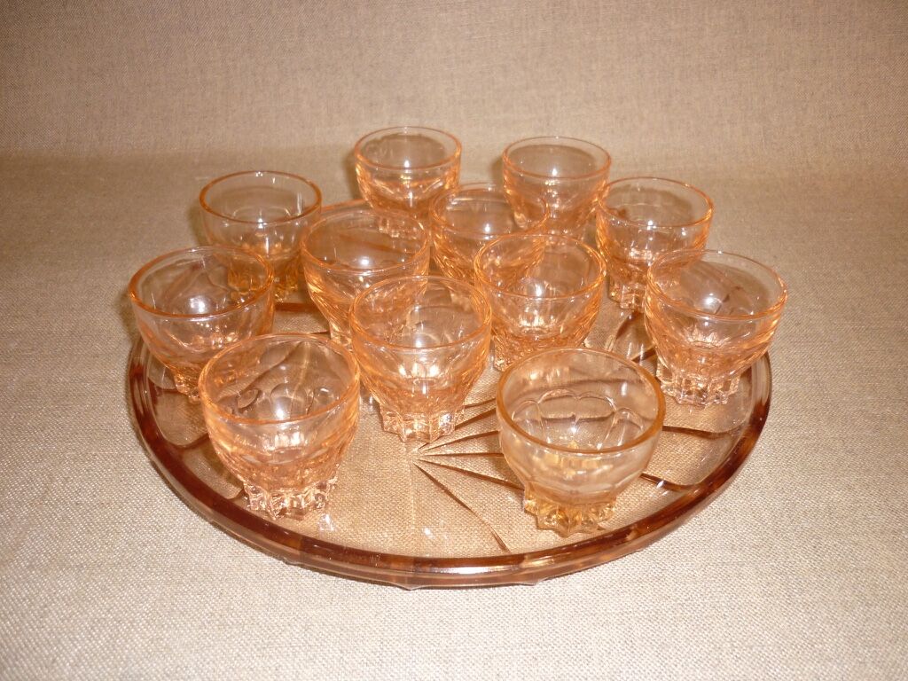 12 shot glasses on pink glass tray