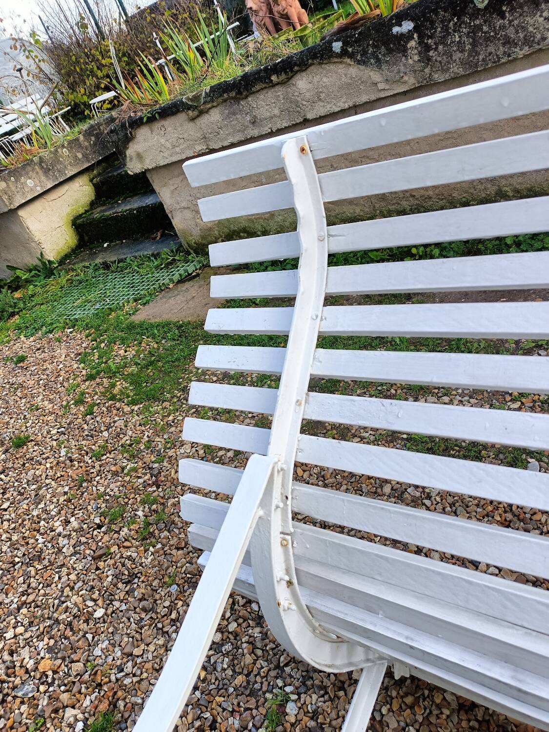 Old garden bench with metal legs and wooden slats