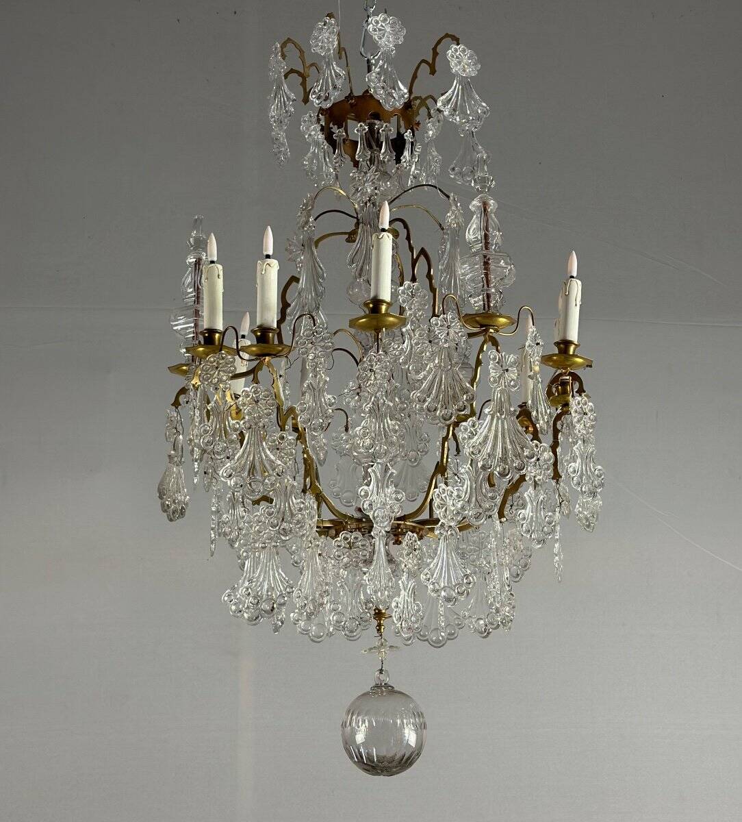 Bronze cage chandelier adorned with molded glass pendants in the shape of peacock feathers, circa 1800