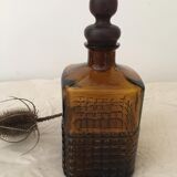 Old amber glass bottle with its wooden and cork stopper