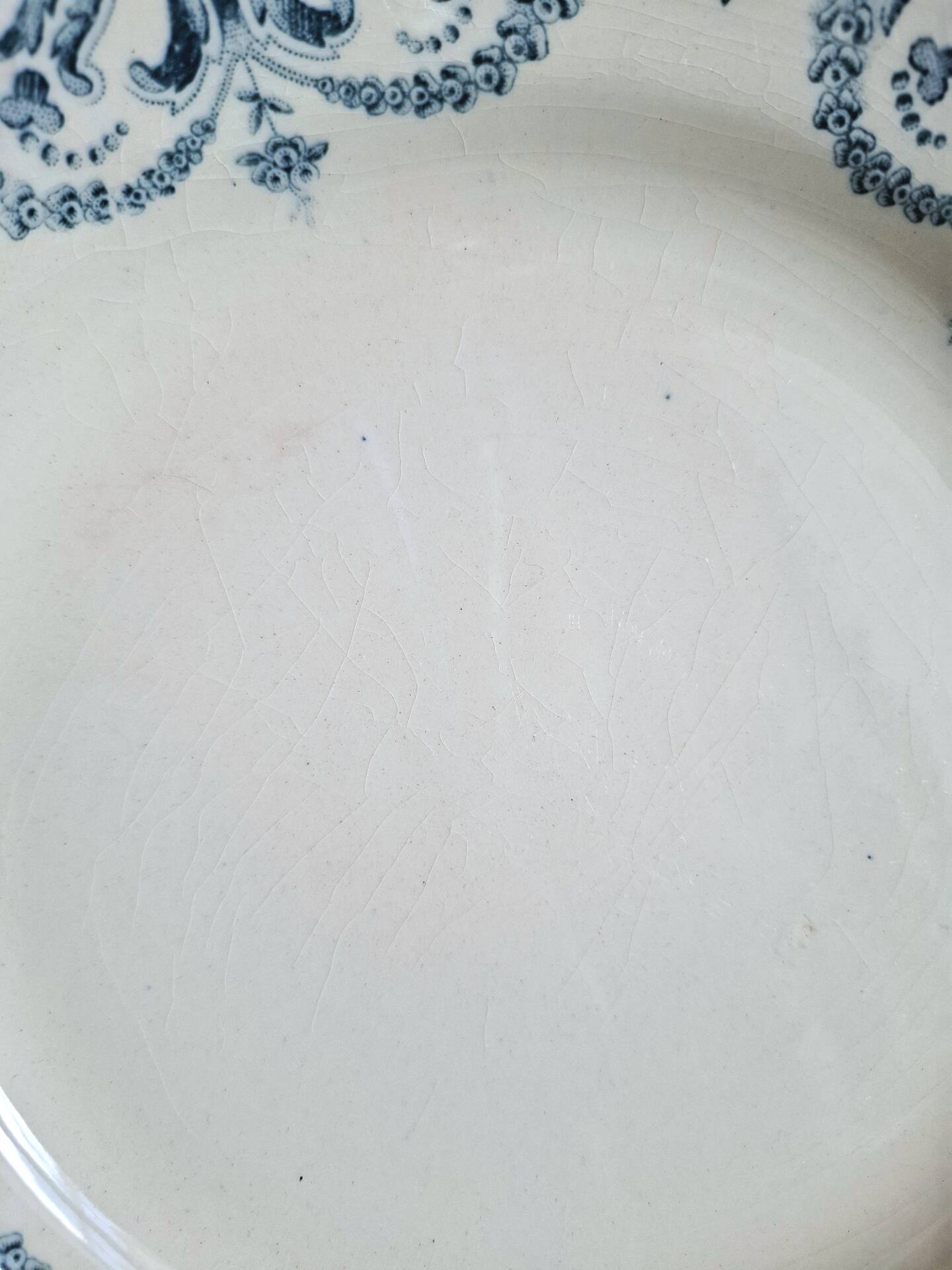 Old mismatched flat plates made of ironstone earthenware.