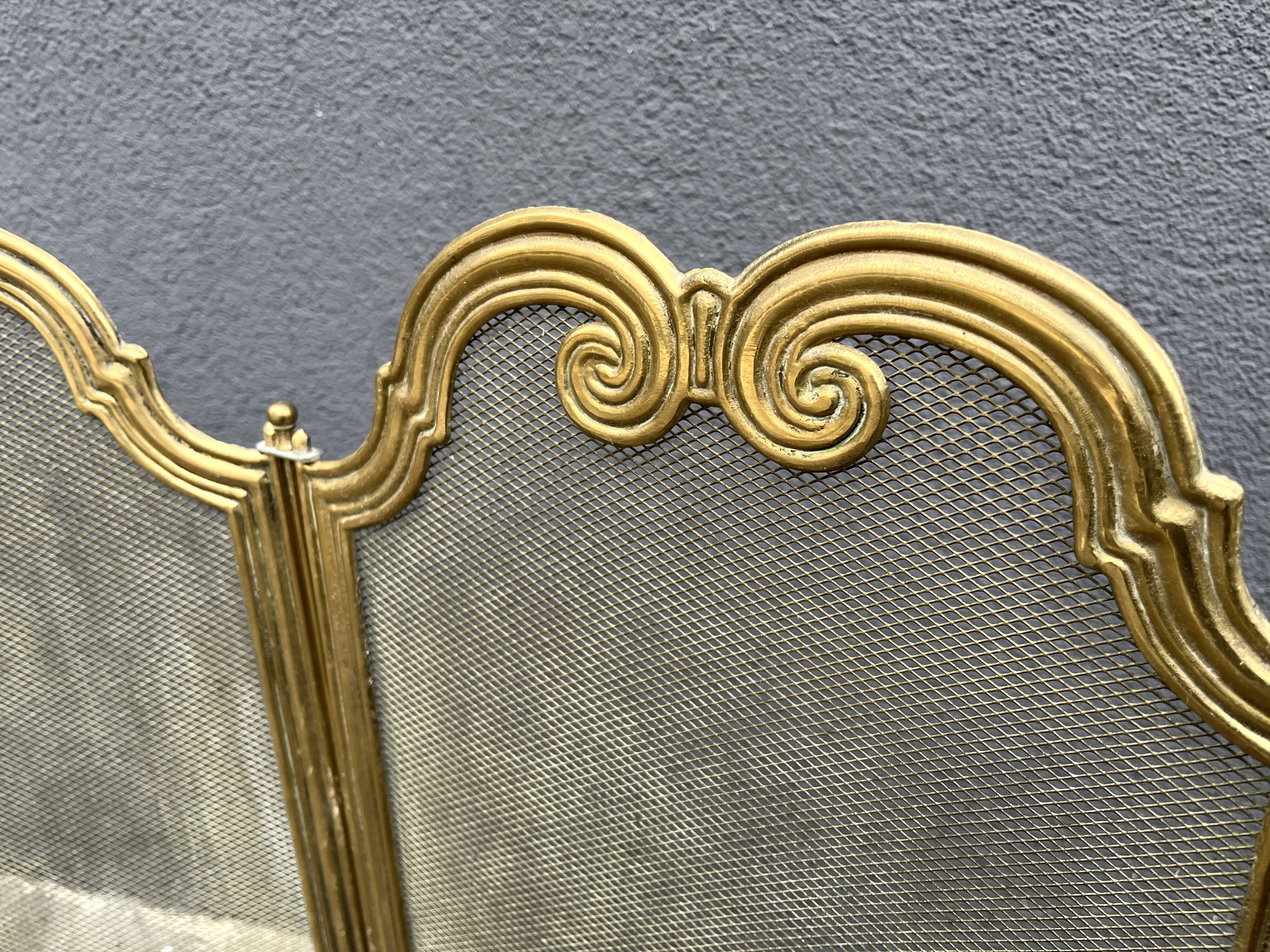 Antique brass fireplace screen from 1920, vintage spark guard.