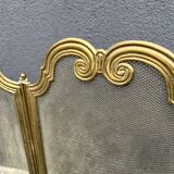 Antique brass fireplace screen from 1920, vintage spark guard.