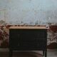 Black chest of drawers with 2 drawers, raw wood top and tapered legs
