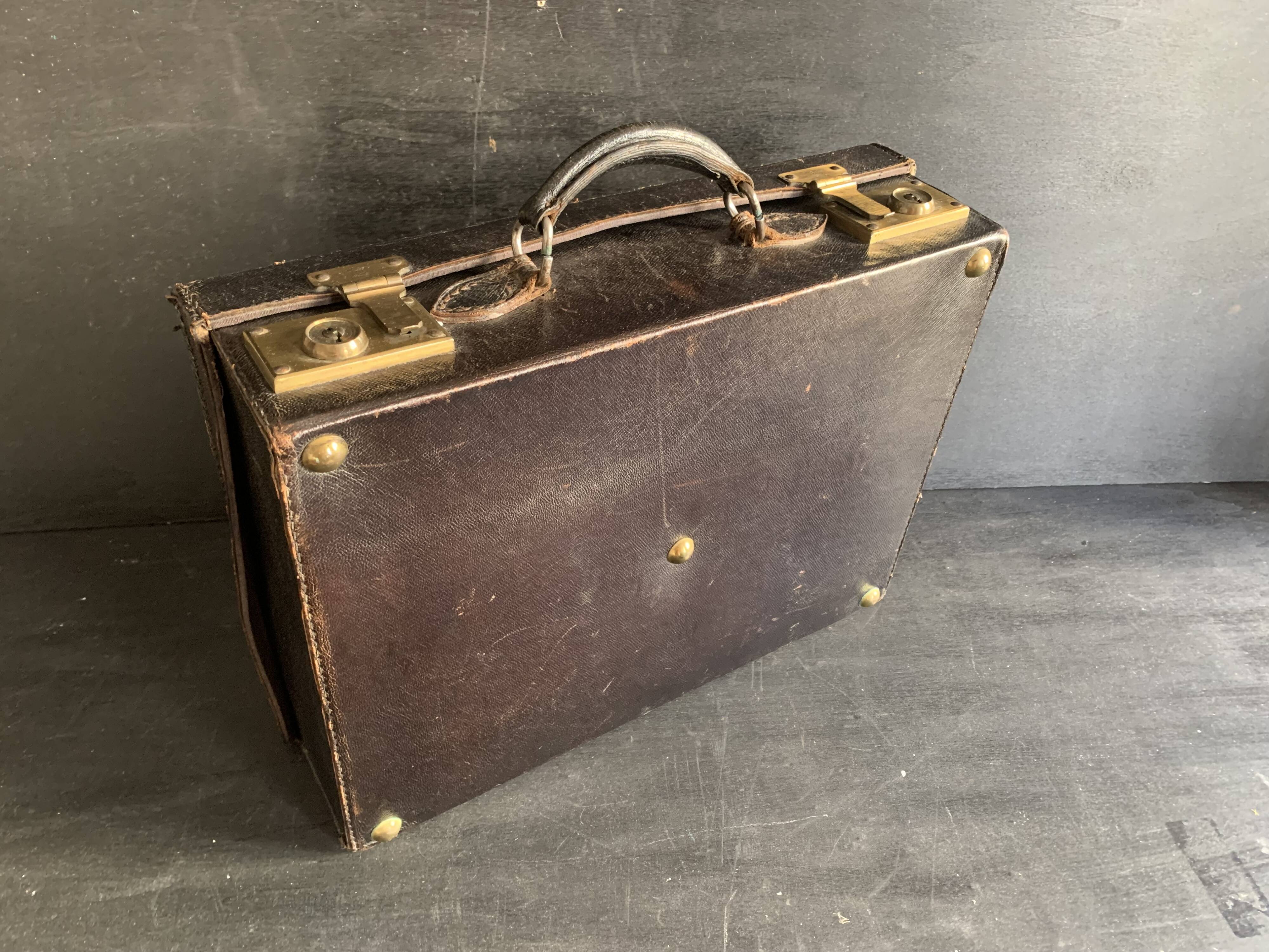 Small black grained leather travel suitcase from the 1920s