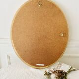 Oval wall mirror in gilded wood