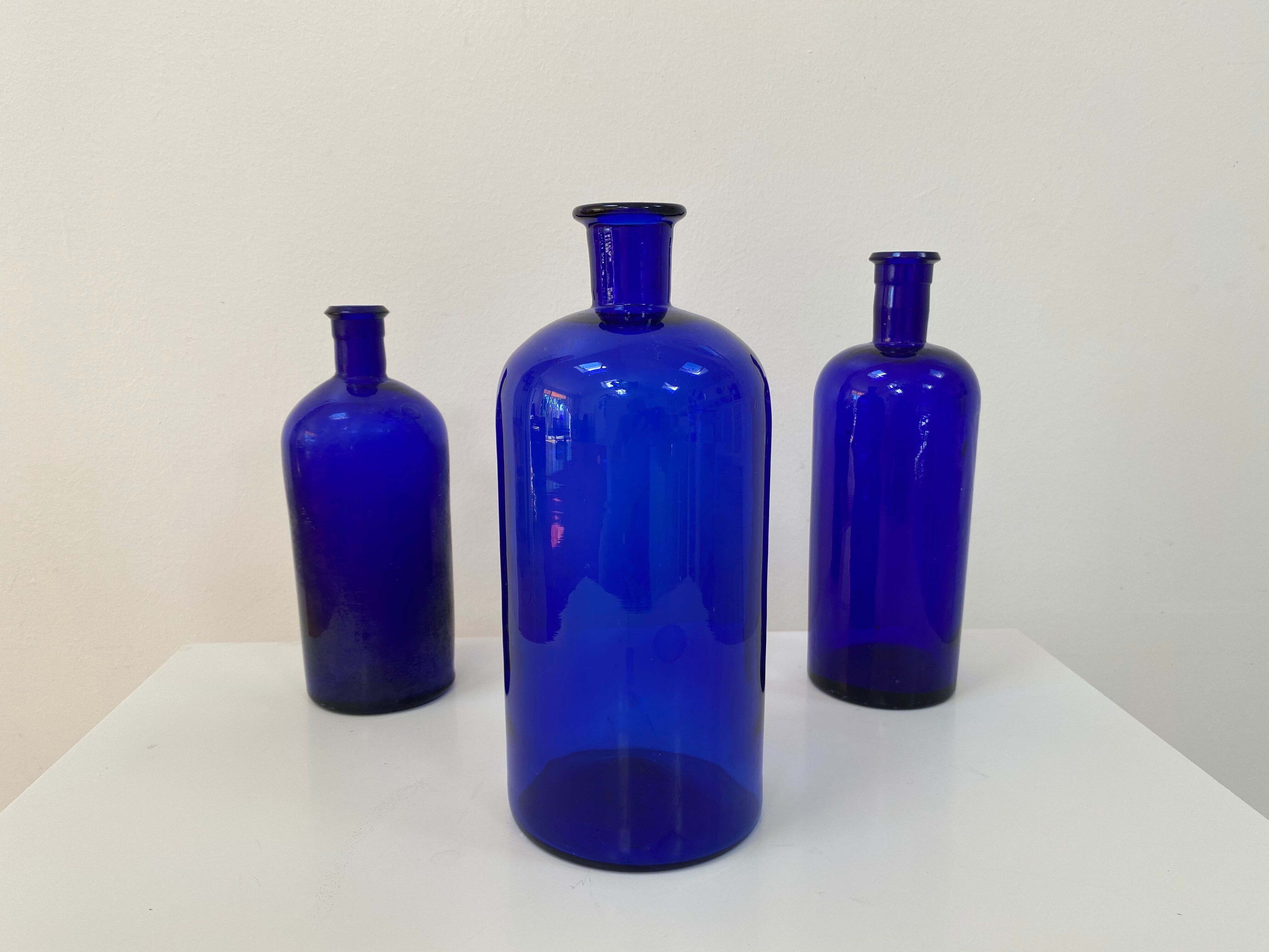 Trio of apothecary bottles in cobalt blue glass